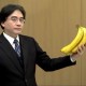 Iwata holding a bunch of bananas